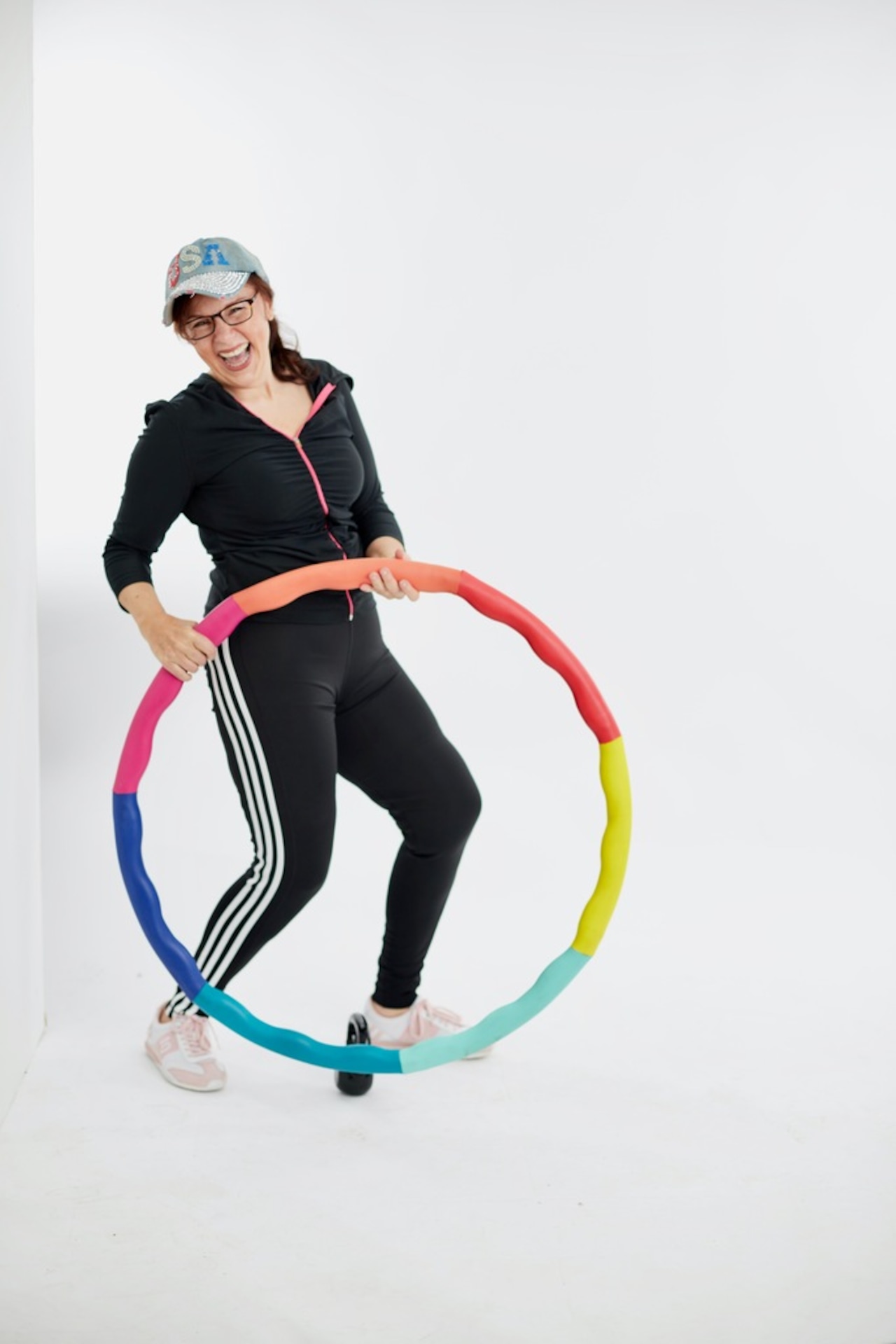 Mary Dimino posing with a rainbow hula hoop